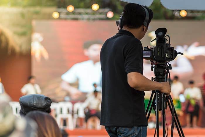 man working camera at event