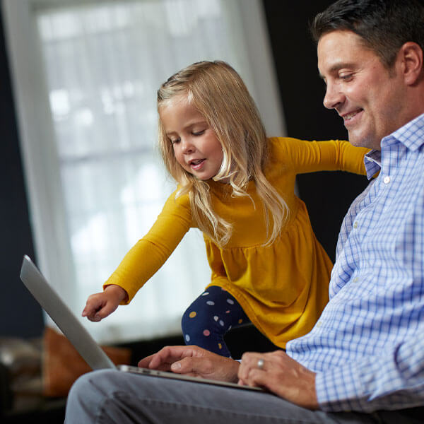 man and daughter on laptop